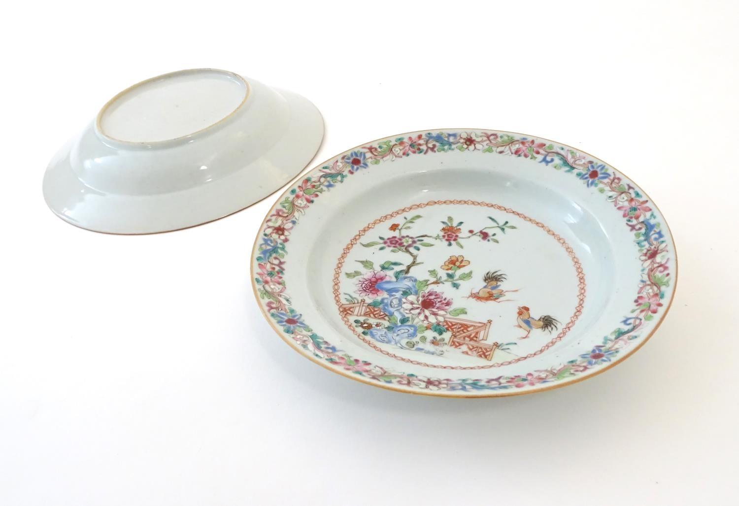 A pair of Chinese dishes decorated with a garden / terrace scene with flowers and foliate with two - Image 4 of 6