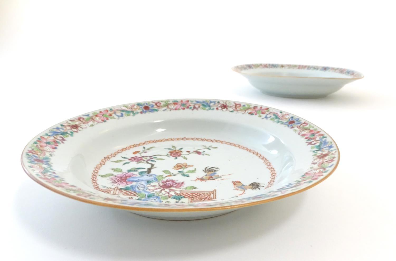 A pair of Chinese dishes decorated with a garden / terrace scene with flowers and foliate with two - Image 2 of 6