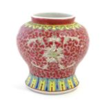 A Chinese famille rose squat vase with a flared base, the body with floral motifs and stylised bat