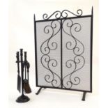 A 20thC wrought iron spark guard / fire screen with scrolling detail. Together with a small