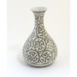 A Chinese baluster vase with a flared rim decorated with stylised scrolling foliage with dotwork