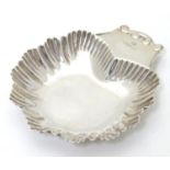 A silver butter dish of shell form hallmarked Chester 1894, maker James Deakin & Son. 3 3/4" long