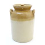A two-tone salt glazed stoneware storage jar and cover with twin handles. Marked 1 gallon by Price