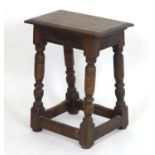 A 19thC oak joint stool with a moulded rectangular top above four turned tapering supports above a