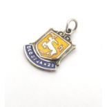 A silver pendant charm with enamel decoration depicting the star sign Capricorn and titles Dec 22 to