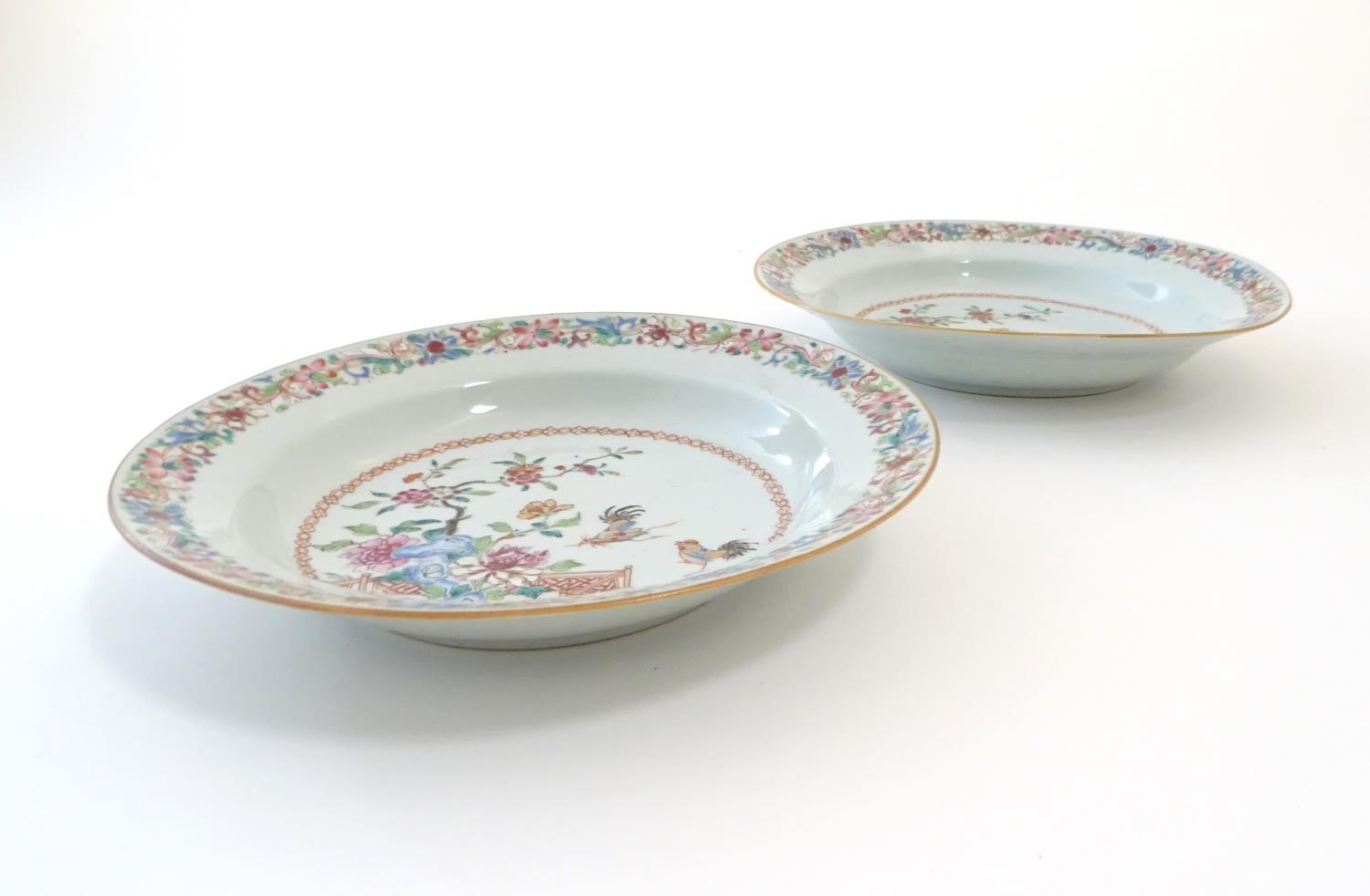 A pair of Chinese dishes decorated with a garden / terrace scene with flowers and foliate with two - Image 5 of 6