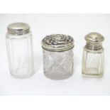 Three various silver lidded glass dressing table/scent bottles. screw-top scent bottle with glass