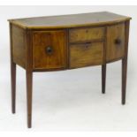A late 18thC Sheraton style mahogany sideboard with a bowed crossbanded top above an inlaid frame