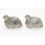 A pair of novelty white metal salt and pepper shakers formed as quail birds. 2" high x 3" long