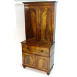 A mid 19thC mahogany secretaire bookcase, having a moulded cornice above two flame mahogany panelled
