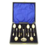 A set of six silver tea/coffee spoons with sugar tongs and sifting spoon en suite, all with rococo