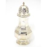 A silver sugar caster of octagonal baluster form. Hallmarked London 1918, maker JW Benson Ltd.