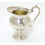 A silver cream jug hallmarked London 1906 maker William Comyns 4 1/2" high Please Note - we do not