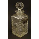 An early 20thC glass decanter of squared form. Together with a silver plate wine label / bottle