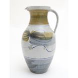 A large studio pottery jug by Andrew Hague, Askrigg Pottery with stylised scrolling foliate brush