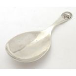 A silver caddy spoon with scallop shell decoration to handle. Hallmarked Birmingham 1926 maker