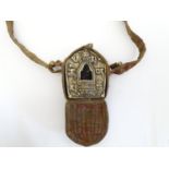 A Tibetan Gau Ghau / prayer box / portable shrine, the embossed face with central glass window