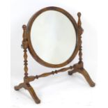 An early 20thC mahogany dressing table mirror with turned uprights supporting a circular mirror. 16"
