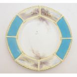 A Royal China Works Worcester octagonal plate with a turquoise border with hand painted landscape