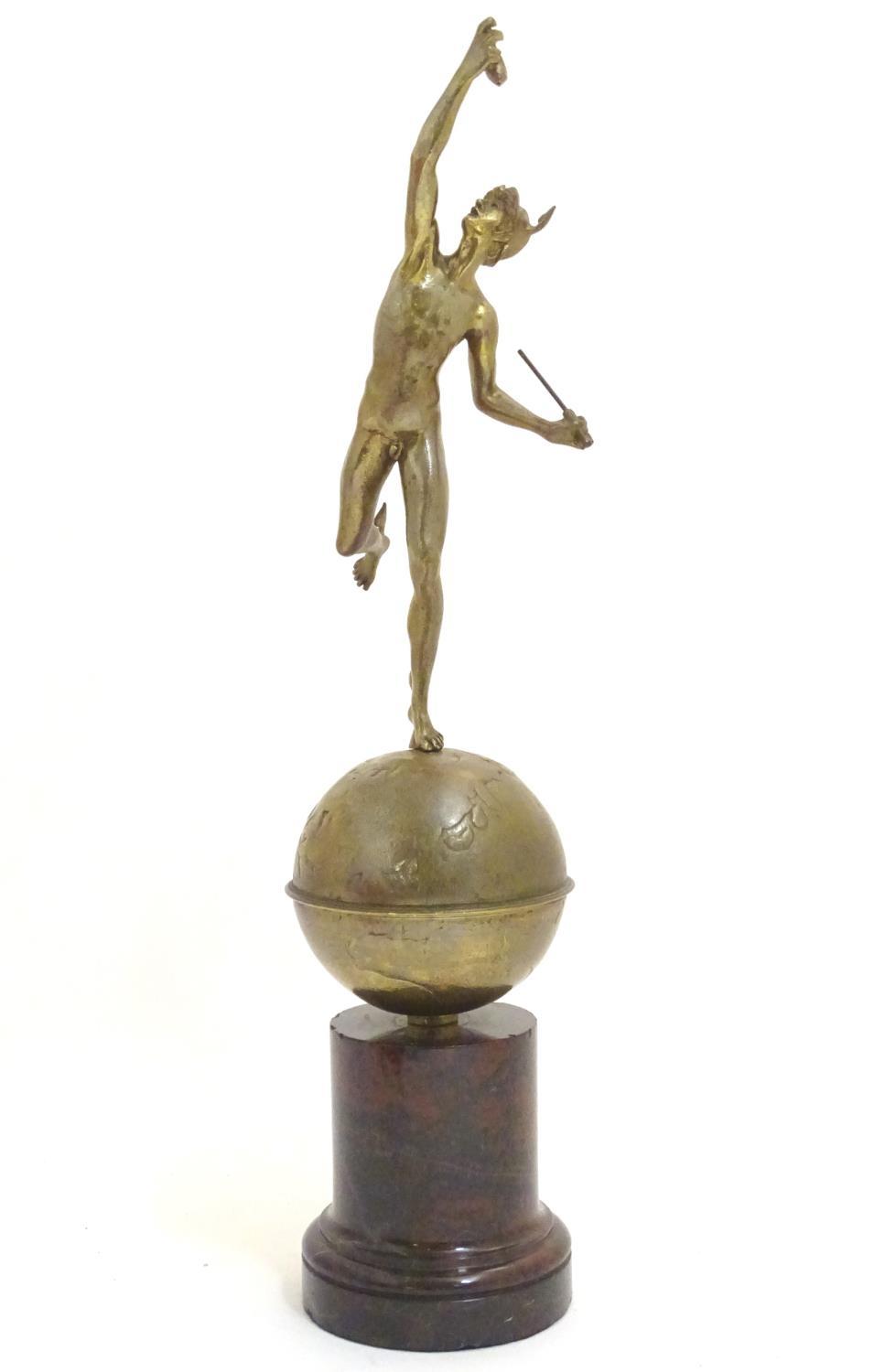 A cast sculpture modelled as Mercury / Hermes on top of the world, on a serpentine base. Approx.