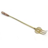 A late 19thC / early 20thC brass toasting fork with marble handle 20" long Please Note - we do not