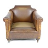 An early / mid 20thC brown leather armchair raised on turned front legs and block back legs