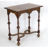 An early 20thC Queen Ann style walnut side table, having a crossbanded rectangular top with
