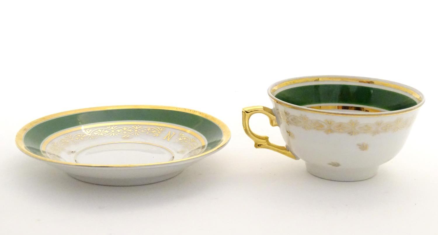 A French tea cup and saucer depicting Emperor Napoleon with green and gilt highlights. Porcelaine de - Image 5 of 10