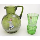 A Victorian olive green glass jug with Mary Gregory style decoration together with a green glass