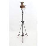 An Arts and crafts wrought iron and copper telescopic standard lamp in the style of WAS Benson.