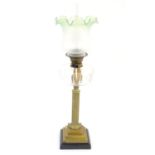 A late 19thC / early 20thC oil lamp, the brass column on stepped base supporting a clear cut glass