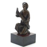 A bronze model of a classical figure kneeling with a large scroll. Approx. 7" high overall Please