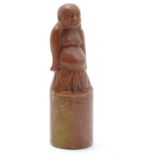 An Oriental carved soapstone seal of cylindrical form, the upper section modelled as Buddha. Approx.
