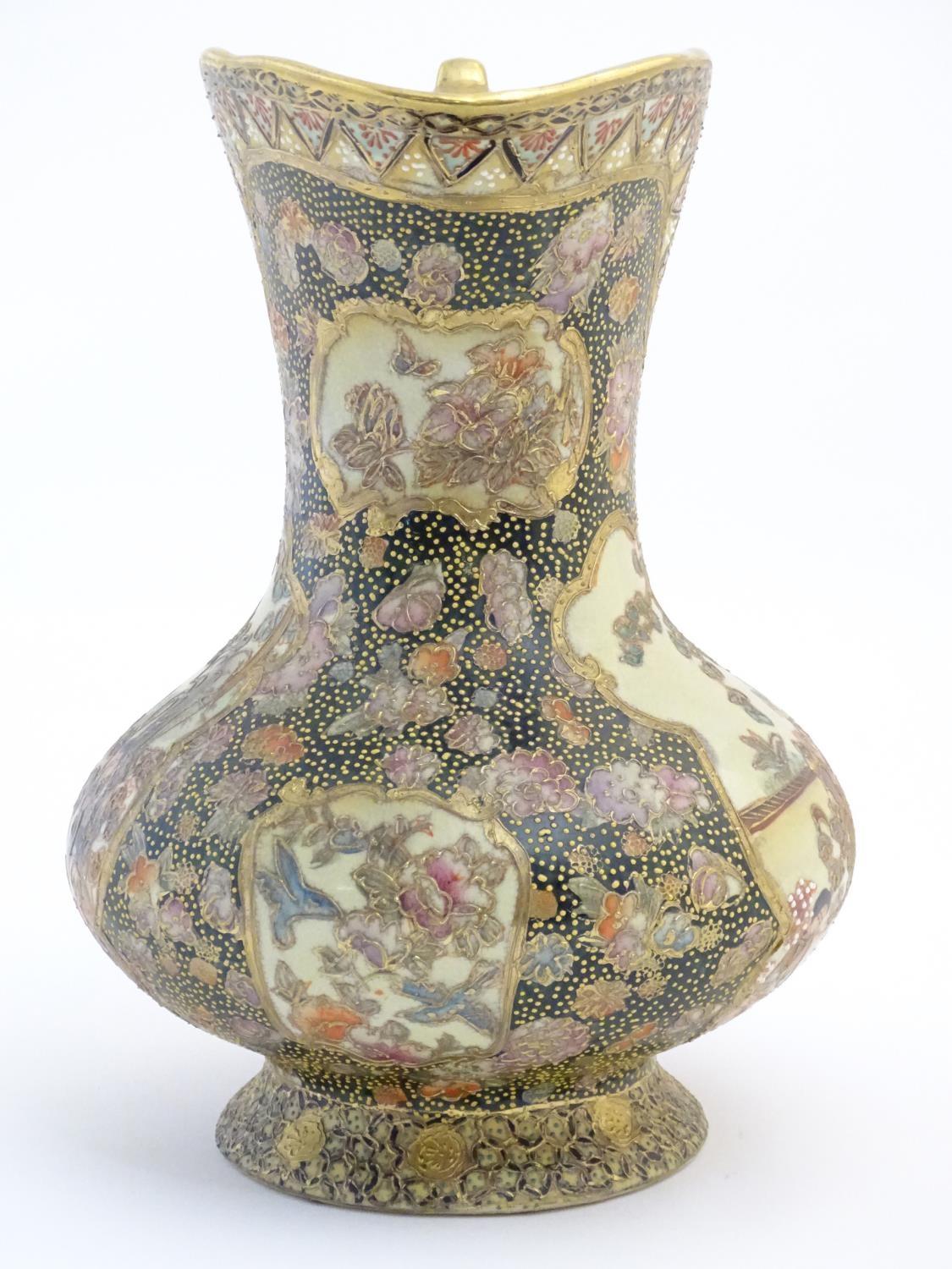 An Oriental jug / ewer with a bulbous body decorated with panels depicting ladies in a garden - Image 5 of 8