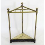A late 19thC brass stick stand of triangular form, having a slatted top above turned supports and