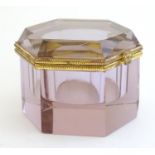 A hexagonal glass pot pale amethyst in colour within hinged lid opening to reveal well recess within