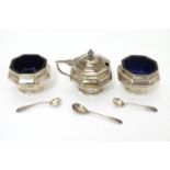 A silver three piece cruet set of octagonal form comprising mustard pot and two salts, with blue