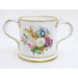 A 19thC loving cup with hand painted floral display to one side and gilt inscription 'Thomas