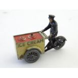 Toy: An early 20thC diecast model of an ice cream vendor and cart / tricycle. Approx. 2 1/2" high