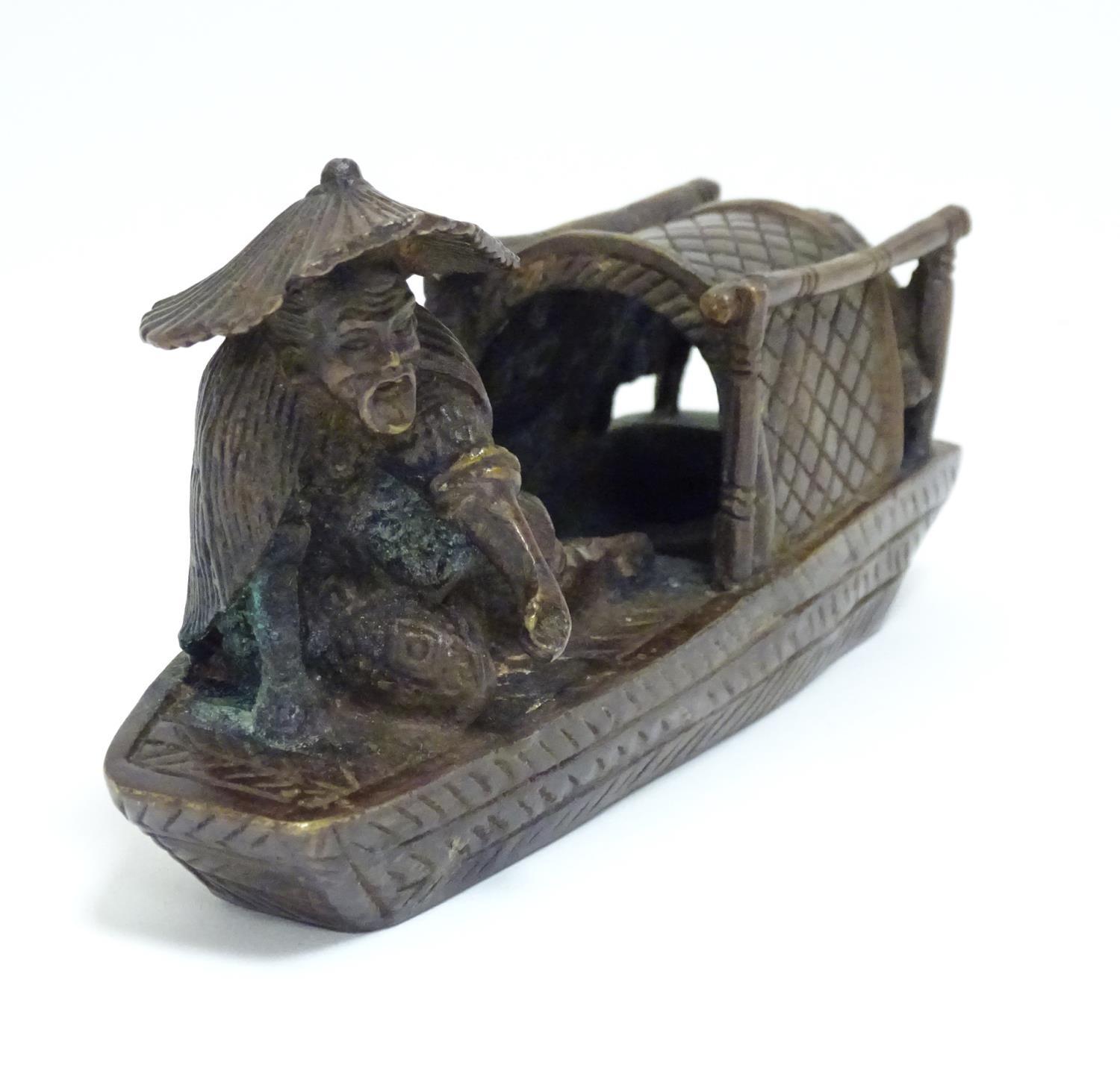 An Oriental bronze model of a fishing boat with a figure fishing. Approx. 6 1/2" long Please - Image 3 of 7