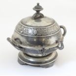An American silver plated twin-handled butter dish with embossed foliate decoration, the hinged