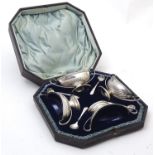 A cased set of 4 Victorian silver salts with blue glass liners. Hallmarked Sheffield 1883 maker