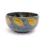 A Royal Doulton stoneware bowl with banded autumnal foliate leaf decoration on a mottled blue