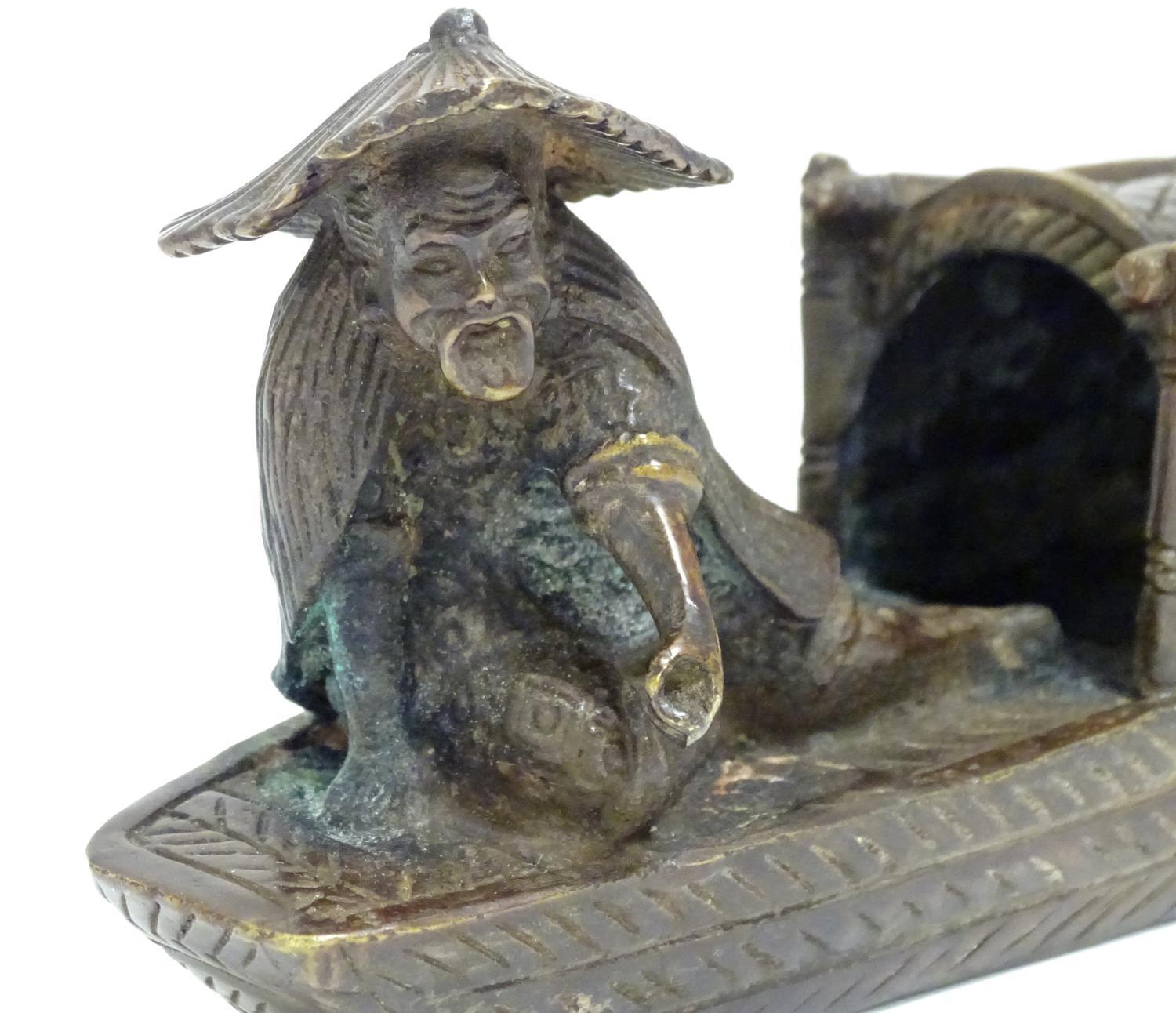 An Oriental bronze model of a fishing boat with a figure fishing. Approx. 6 1/2" long Please - Image 2 of 7