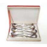 A boxed set of 6 silver plate coffee spoons with amber coloured cabochon finials, the box marked