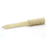 A late 19thC bone letter opener with a carved handle. Approx. 8 1/2" long Please Note - we do not