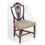 A 19thC mahogany Hepplewhite style side chair, with a shield shaped backrest having urn and swag
