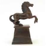 An early 20thC bronze model of a rearing horse, on a tapered plinth base. Approx. 5 3/4" overall