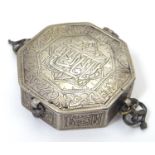 A white metal box of octagonal form decorated with Islamic style script. Approx 2" wide Please