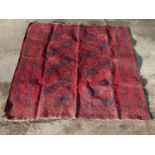 Carpet / Rug : A large rug with a red ground and 8 central medallions of geometric form, with